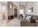 Spacious living area with a large sectional sofa, hardwood floors, and a built-in shelving unit at 3975 N Hualapai Way # 266, Las Vegas, NV 89129