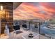 Balcony with chairs and table offers stunning sunset view at 4269 Solace St # 0, Las Vegas, NV 89135