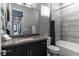 Modern bathroom featuring gray tile, tub and a dark vanity at 4269 Solace St # 0, Las Vegas, NV 89135