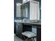 Bathroom vanity featuring dark cabinets, makeup counter, and a soft stool at 4269 Solace St # 0, Las Vegas, NV 89135