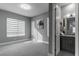 A carpeted bedroom with large windows and modern gray wall color at 4269 Solace St # 0, Las Vegas, NV 89135