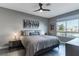 Comfortable bedroom with large window, ceiling fan, and decorative wall art at 4269 Solace St # 0, Las Vegas, NV 89135