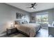 Bedroom featuring a large bed, ceiling fan, and a sunlit view at 4269 Solace St # 0, Las Vegas, NV 89135