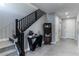 Inviting foyer featuring a staircase with black railings and modern decor at 4269 Solace St # 0, Las Vegas, NV 89135