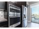 Stainless steel appliances including double ovens and refrigerator in modern kitchen at 4269 Solace St # 0, Las Vegas, NV 89135