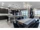Spacious kitchen featuring dark cabinetry, quartz countertops, and stainless steel appliances at 4269 Solace St # 0, Las Vegas, NV 89135