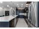 Modern kitchen with long island, stainless steel appliances, and dark cabinetry at 4269 Solace St # 0, Las Vegas, NV 89135