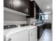 Modern laundry room with front load washer and dryer and plenty of storage space at 4269 Solace St # 0, Las Vegas, NV 89135