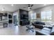 Open-concept living room with tile floors, a sleek sofa, and plenty of natural light at 4269 Solace St # 0, Las Vegas, NV 89135