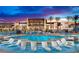 Resort-style pool with lounge chairs and palm trees at clubhouse at 4269 Solace St # 0, Las Vegas, NV 89135