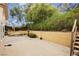 Fenced backyard offers a peaceful retreat with a fountain and mature trees at 4401 Inez Dr, Las Vegas, NV 89130