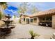 Charming backyard with a stone fountain, patio area, and a glimpse of the home's exterior, creating an inviting outdoor space at 4401 Inez Dr, Las Vegas, NV 89130