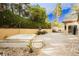 Spacious backyard featuring a hot tub, water fountain, and lush greenery at 4401 Inez Dr, Las Vegas, NV 89130