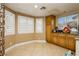 Bright eat-in kitchen features tile flooring, granite counters, and warm wooden cabinetry at 4401 Inez Dr, Las Vegas, NV 89130
