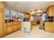 Open kitchen features warm wooden cabinets and granite countertops, with an adjacent breakfast area at 4401 Inez Dr, Las Vegas, NV 89130
