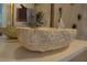 Close-up of a unique carved stone vessel sink in a stylish powder room at 4525 Dean Martin Dr # 2406, Las Vegas, NV 89103