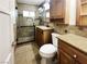 Clean bathroom with shower, toilet, and wood vanity at 484 National St, Henderson, NV 89015