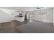 Spacious living room with dark laminate floors and a ceiling fan at 4922 Canna Lily St, Las Vegas, NV 89122