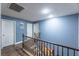 Upstairs hallway with light blue walls and wood flooring at 5031 Naff Ridge Dr, Las Vegas, NV 89131