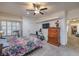 Bright bedroom featuring a ceiling fan, wood-look floors, and furniture perfect for a home gym at 508 Indian Princess Dr # 101, Las Vegas, NV 89145