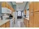 Bright kitchen with white appliances and wood cabinets at 5524 Desert Valley Dr, Las Vegas, NV 89149