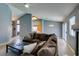 Living room with sectional sofa, coffee table and view of kitchen at 5524 Desert Valley Dr, Las Vegas, NV 89149