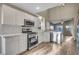 Modern white kitchen with stainless steel appliances and herringbone backsplash at 558 Poplar Leaf St, Las Vegas, NV 89144