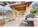 Outdoor BBQ area with covered seating and a grill at 5751 E Hacienda Ave # 118, Las Vegas, NV 89122