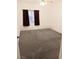 Bright carpeted bedroom with window and maroon curtains at 5751 E Hacienda Ave # 118, Las Vegas, NV 89122