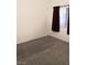 Spacious carpeted bedroom with window and maroon curtains at 5751 E Hacienda Ave # 118, Las Vegas, NV 89122