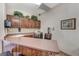 Community kitchen with wood cabinets, microwave, and countertop seating at 5751 E Hacienda Ave # 118, Las Vegas, NV 89122