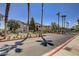 Community entrance with palm trees and building view at 5751 E Hacienda Ave # 118, Las Vegas, NV 89122