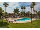 Community pool and spa with palm trees and seating at 5751 E Hacienda Ave # 118, Las Vegas, NV 89122