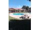 Community pool with patio furniture and lush lawn at 5751 E Hacienda Ave # 118, Las Vegas, NV 89122
