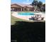 Community pool with a table and stone benches at 5751 E Hacienda Ave # 118, Las Vegas, NV 89122
