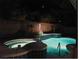 Night view of a pool and spa with festive lights at 5851 Magini Ave, Las Vegas, NV 89141