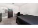 Spacious bedroom with a dresser, desk, and large bed, plus ensuite bathroom at 6701 Squaw Mountain Dr # 203, Las Vegas, NV 89130