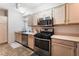 Modern kitchen, stainless steel appliances, light wood cabinets at 6701 Squaw Mountain Dr # 203, Las Vegas, NV 89130