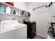 Laundry room with washer, dryer, and ample shelving for storage at 6701 Squaw Mountain Dr # 203, Las Vegas, NV 89130