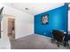 Bright bedroom with blue accent wall, carpeted floor, and a built-in workspace at 6701 Squaw Mountain Dr # 203, Las Vegas, NV 89130