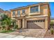 Two-story house with a large garage and well-maintained landscaping at 6780 W Cougar Ave, Las Vegas, NV 89139