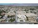 An aerial view of a home in a residential neighborhood with mountain views in the distance at 7390 W Rome Blvd, Las Vegas, NV 89131