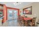 Bright dining area with a wooden table, chairs and access to the backyard at 7390 W Rome Blvd, Las Vegas, NV 89131