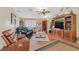Spacious living room with hardwood floors, leather furniture, and a large entertainment center at 7390 W Rome Blvd, Las Vegas, NV 89131