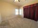 Spacious bedroom with a ceiling fan, carpeted floors, and a window at 7633 Winterthur Ct, Las Vegas, NV 89129