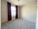 Standard bedroom features an arched window, neutral carpet, and neutral paint at 7633 Winterthur Ct, Las Vegas, NV 89129