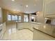 Bright, open kitchen with white cabinets, tile flooring, granite countertops, and views into the breakfast nook and dining room at 7633 Winterthur Ct, Las Vegas, NV 89129