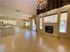 Spacious living room features wood floors, fireplace, and modern chandelier lighting at 7633 Winterthur Ct, Las Vegas, NV 89129