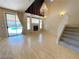 Spacious living room with hardwood floors, fireplace, and pool view at 7633 Winterthur Ct, Las Vegas, NV 89129