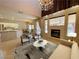 Bright living room features a fireplace, chandelier, and flows into an open kitchen and dining area at 7633 Winterthur Ct, Las Vegas, NV 89129